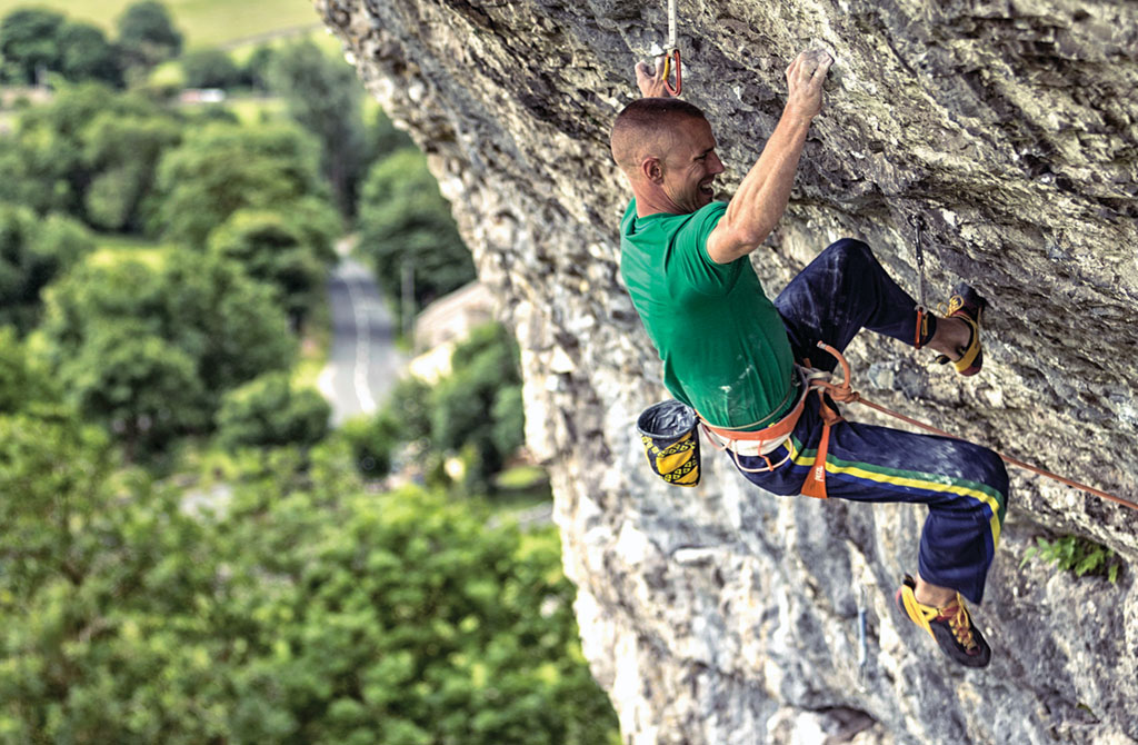 Neil Gresham on the hard approach section to the roof on Freakshow (F8c) at Kilnsey. Photo: Lukasz Warzecha