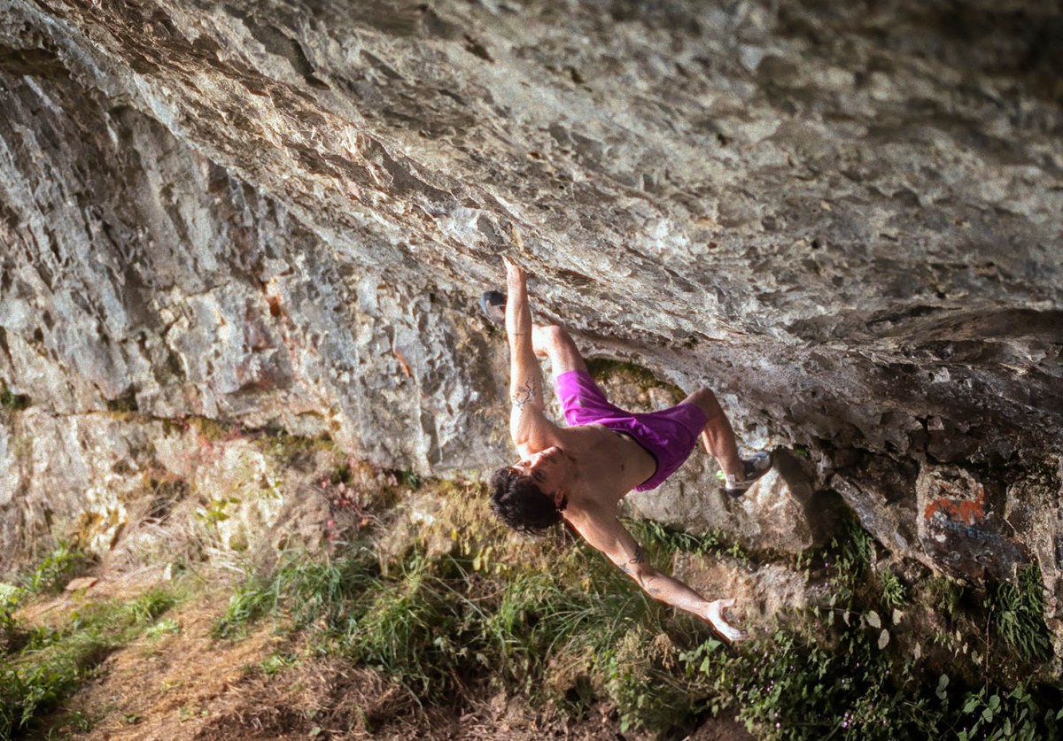 Max Milne eyes up the upper section of Bewilderness (Font 8B+) at Badger Cove, Peak District. Photo: Band of Birds